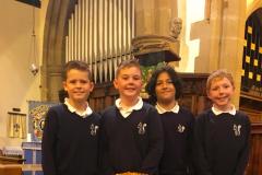 Youngsters present harvest donations to local food bank