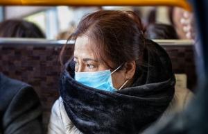 Bus passenger in mask (stock image)