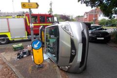 Firefighters rescue woman trapped in flipped car