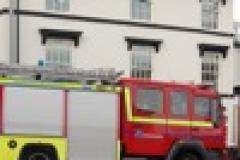 Fire fighters extinguish car fire