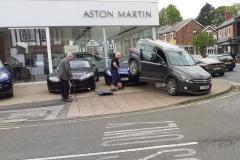 Driver loses control and mounts Aston Martin sports car