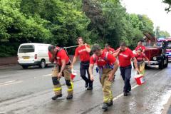 Firefighters pull through the rain for charity