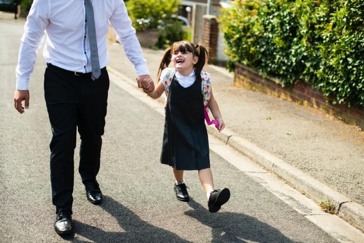 Father walking daughter to school