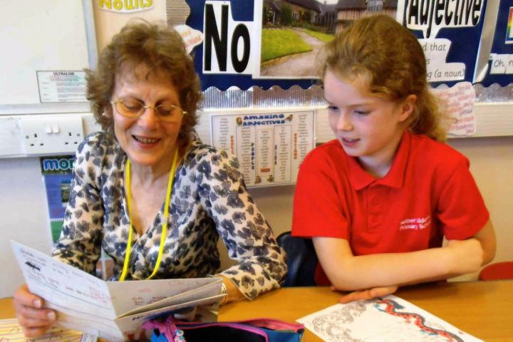 Griselda Garner reading a story written by one of the children